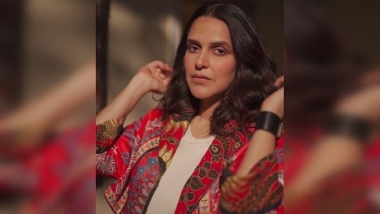 Neha Dhupia wore a long neutral shade dress underneath the jacket to make the coat stands out.(Instagram/@nehadhupia)