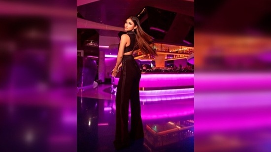 Mouni Roy picked the perfect location for her photoshoot. Mouni Roy posed like a diva in front of a fancy bar with neon lighting.(Instagram/@imouniroy)