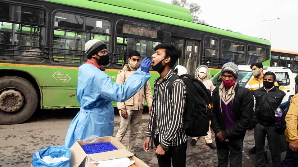 A health worker collects a swab sample for Covid-19 test at Anand Vihar on Thursday. (Sanjeev Verma/HT Photo) A health worker collects a swab sample for Covid-19 test at Anand Vihar on Thursday. (Sanjeev Verma/HT Photo)