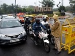 Delhi Police personnel stopping vehicles at a road checkpoint as Delhi is under a weekend curfew. (ANI) Delhi Police personnel stopping vehicles at a road checkpoint as Delhi is under a weekend curfew. (ANI)