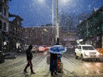 People walk with umbrellas during snowfall, in Srinagar on Friday.(PTI Photo) People walk with umbrellas during snowfall, in Srinagar on Friday.(PTI Photo)