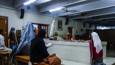 Nuns and others pray beside the tomb of Saint Teresa, the founder of the Missionaries of Charity at its headquarter in Kolkata. (AP File Photo) Nuns and others pray beside the tomb of Saint Teresa, the founder of the Missionaries of Charity at its headquarter in Kolkata. (AP File Photo)