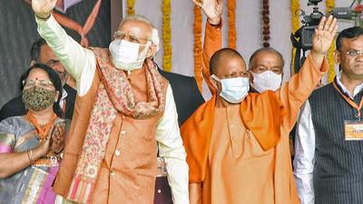 Prime Minister Narendra Modi and Uttar Pradesh chief minister Yogi Adityanath wave to their supporters during the foundation stone laying ceremony of Major Dhyan Chand Sports University, in Meerut. (ANI) Prime Minister Narendra Modi and Uttar Pradesh chief minister Yogi Adityanath wave to their supporters during the foundation stone laying ceremony of Major Dhyan Chand Sports University, in Meerut. (ANI)