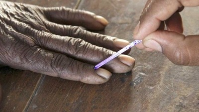 A voting official marks the finger of a voter inside a polling booth. (For representation purpose) (Reuters)