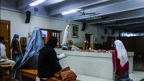 Nuns and others pray beside the tomb of Saint Teresa, the founder of the Missionaries of Charity at its headquarter in Kolkata. (AP File Photo) Nuns and others pray beside the tomb of Saint Teresa, the founder of the Missionaries of Charity at its headquarter in Kolkata. (AP File Photo)