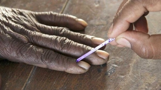 A voting official marks the finger of a voter inside a polling booth. (Reuters) (For representation purpose)