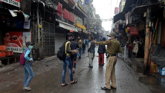 A policeman directs pedestrians to return home during weekend curfew imposed to curb the spread of the coronavirus in New Delhi.(AP)