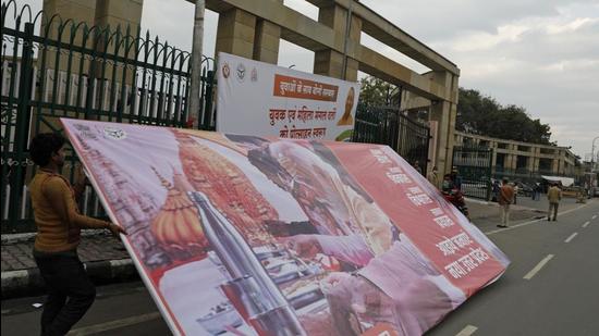 Workers remove a hoarding displaying an image of Prime Minister Narendra Modi in Lucknow, Uttar Pradesh. The Election Commission has announced dates for state elections in Uttar Pradesh and four other states (AP)