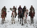 Taliban fighters pose for pictures while riding rental horses during a snowfall at the Qargha lake in Kabul. Taliban fighters pose for pictures while riding rental horses during a snowfall at the Qargha lake in Kabul.