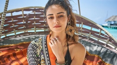 The pictures feature Ananya donning a black halter bralette top, layered with a tangerine printed shrug and a pair of high-waist tangerine printed pants all from Falguni Shane Peacock. (Instagram/ananyapanday ) The pictures feature Ananya donning a black halter bralette top, layered with a tangerine printed shrug and a pair of high-waist tangerine printed pants all from Falguni Shane Peacock. (Instagram/ananyapanday )