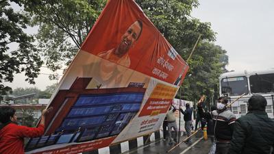 Municipal workers remove political hoardings in Lucknow on Sunday, a day after the EC announced dates for Assembly elections in Uttar Pradesh. (AP) Municipal workers remove political hoardings in Lucknow on Sunday, a day after the EC announced dates for Assembly elections in Uttar Pradesh. (AP)