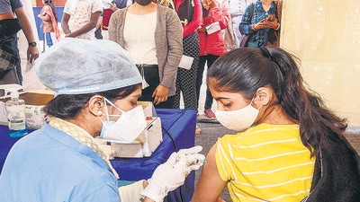 A health worker administers a dose of Covid-19 vaccine to teenager at Patliputra Sport Complex, in Patna, on Sunday. (PTI)