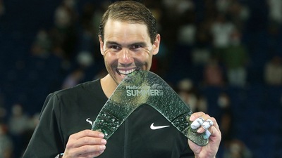 Rafael Nadal of Spain holds his winner's trophy after his singles match against Maxime Cressy of the United States (AP)