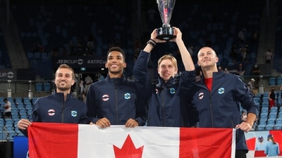 Canada's Steven Diez, Felix Auger-Aliassime, Denis Shapovalov and Brayden Schnur pose with the trophy and their national flag as they celebrate after winning the ATP Cup&nbsp; (REUTERS)
