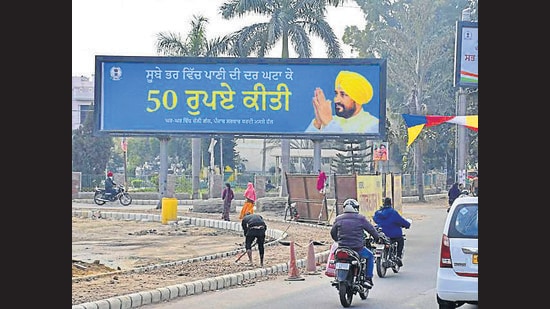 These hoardings promote the recent decisions taken by the ruling party, including waiving off pending power arrears for consumers with connections up to 2KW, reducing water tariff for residential buildings, and reducing the power tariff among other welfare schemes. (Harsimar Pal Singh/HT)