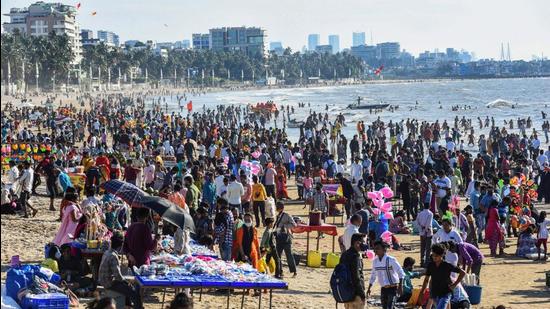 People gather at the Juhu beach amid restrictions imposed due to rising Covid-19 cases in Mumbai on Sunday. (PTI)