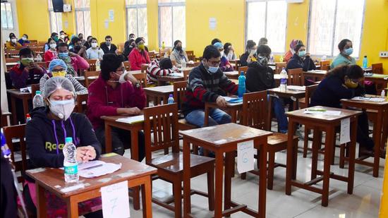 Aspirants maintain Covid protocols in an exam hall while attending the West Bengal State Eligibility Test (WBSET) at a college, in Kolkata on Sunday. (ANI)