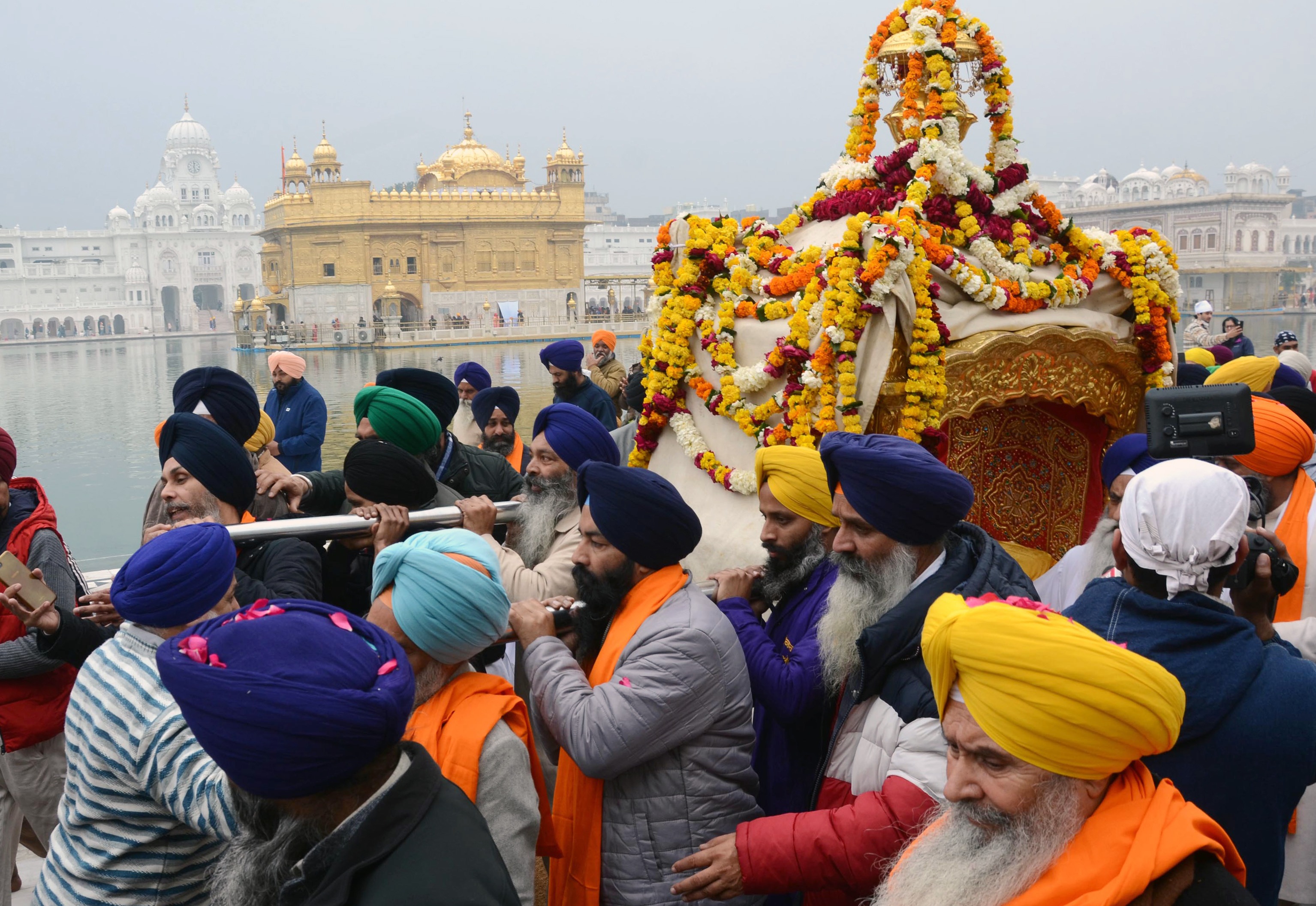 Devotees carry a holy book of Guru Granth Sahib in a golden palanquin on the eve of the birth anniversary of Guru Gobind Singh at the Golden Temple, in Amritsar. (ANI) Devotees carry a holy book of Guru Granth Sahib in a golden palanquin on the eve of the birth anniversary of Guru Gobind Singh at the Golden Temple, in Amritsar. (ANI)