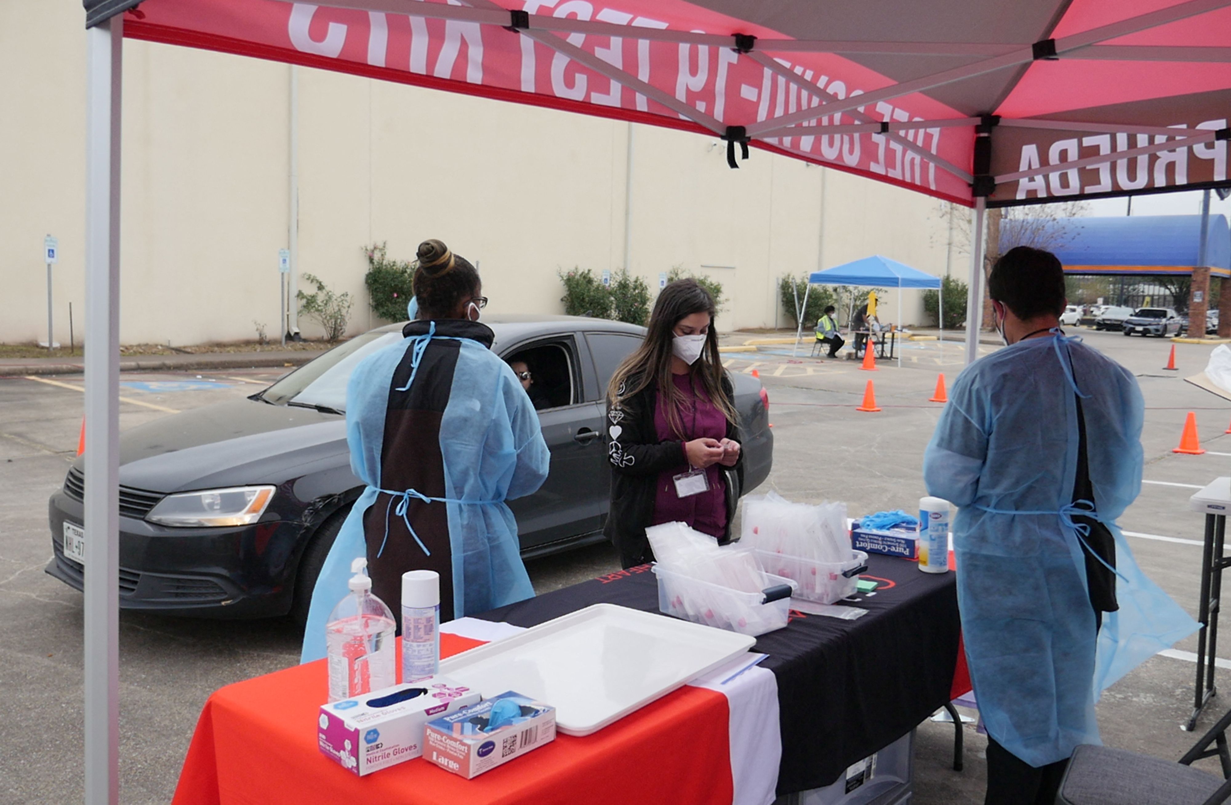 Health workers prepare as people arrive at a Covid-19 testing station in Houston, Texas, to receive a Covid test on January 7, 2022. (AFP) Health workers prepare as people arrive at a Covid-19 testing station in Houston, Texas, to receive a Covid test on January 7, 2022. (AFP)