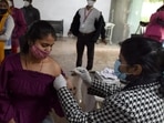 A woman takes a shot of the Covid-19 vaccine at the District Hospital in Noida’s Sector 30 on Sunday. (Sunil Ghosh/HT photo) A woman takes a shot of the Covid-19 vaccine at the District Hospital in Noida’s Sector 30 on Sunday. (Sunil Ghosh/HT photo)