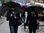 People in Delhi walk under umbrellas amid rainfall on Sunday.(ANI Photo) People in Delhi walk under umbrellas amid rainfall on Sunday.(ANI Photo)