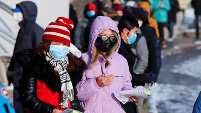 People leave with their Covid-19 antigen test kits after queuing at the Hazeldean Mall in Ottawa, Ontario, Canada. (REUTERS)