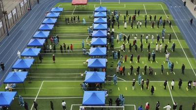 Residents line up on a football field for the coronavirus test in north China’s Tianjin municipality, on Sunday. At least 21 more cases of were reported in the port city of Tianjin, some 130km away from Beijing, the national health commission said . (AP) Residents line up on a football field for the coronavirus test in north China’s Tianjin municipality, on Sunday. At least 21 more cases of were reported in the port city of Tianjin, some 130km away from Beijing, the national health commission said . (AP)