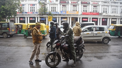 Delhi Police personnel checking vehicles during the weekend curfew to curb the spread of Covid-19 cases, at Connaught Place on Saturday. (ANI File Photo) Delhi Police personnel checking vehicles during the weekend curfew to curb the spread of Covid-19 cases, at Connaught Place on Saturday. (ANI File Photo)