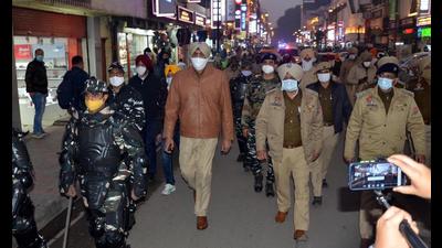 Punjab Police and CRPF personnel take out a flag march ahead of the assembly election, in Amritsar on Monday. (Sameer Sehgal/HT)