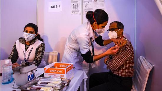 A doctor being inoculated with a booster dose of Covid-19 vaccine, at Ganga Ram Hospital, in New Delhi. (Amal KS/HT Photo)