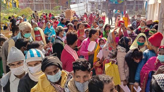 People wait in queues to get themselves tested for Covid-19, at Sri Krishna Medical College and Hospital in Muzaffarpur, on Monday. (PTI)