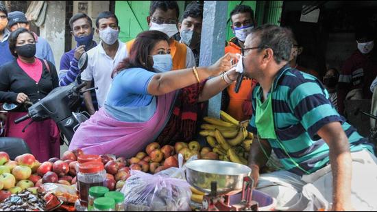 Ruling Trinamool Congress leader Moushami Das distributing masks in Kolkata. (PTI)