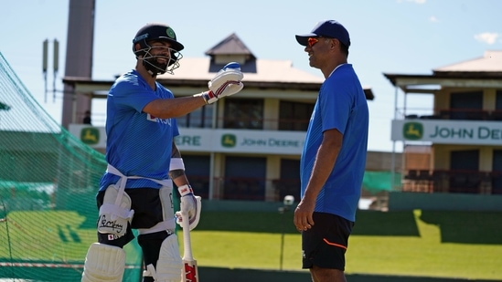 Indian captain Virat Kohli shares a light moment with head coach Rahul Dravid during a practice session ahead of the first test match between India and South Africa.(ANI)