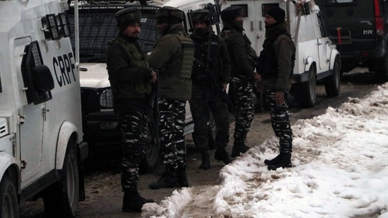 Security personnel stand guard during an encounter between security forces and terrorists in Hasaanpora area of Kulgam. (ANI photo)(Imran Nissar)