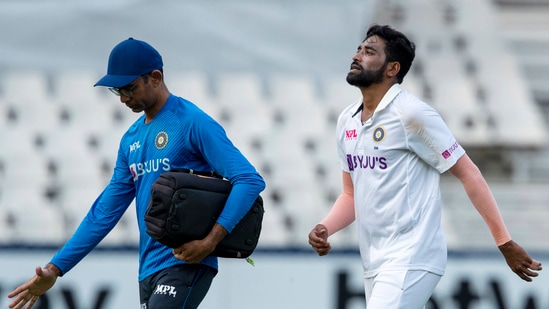 Mohammed Siraj leaves the field with team physio Nitin Patel during the first day of the 2nd Test.&nbsp;(AP)