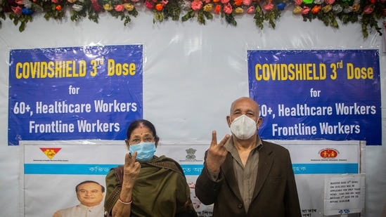An elderly couple show victory sign after receiving third dose of vaccination for Covid-19 at a government hospital in Guwahati.(AP)