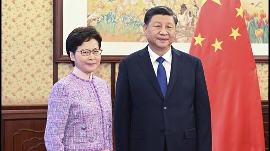 Chinese President Xi Jinping (right) with chief executive of the Hong Kong Special Administrative Region Carrie Lam, during a meeting in Beijing, China, on December 22, 2021. Xi has appointed top Xinjiang police officer as Hong Kong PLA chief. (AP) Chinese President Xi Jinping (right) with chief executive of the Hong Kong Special Administrative Region Carrie Lam, during a meeting in Beijing, China, on December 22, 2021. Xi has appointed top Xinjiang police officer as Hong Kong PLA chief. (AP)
