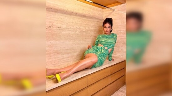Hina Khan went all out and posed for the camera as she held the closet rod with one hand and her hair with the other.(Instagram/@realhinakhan)