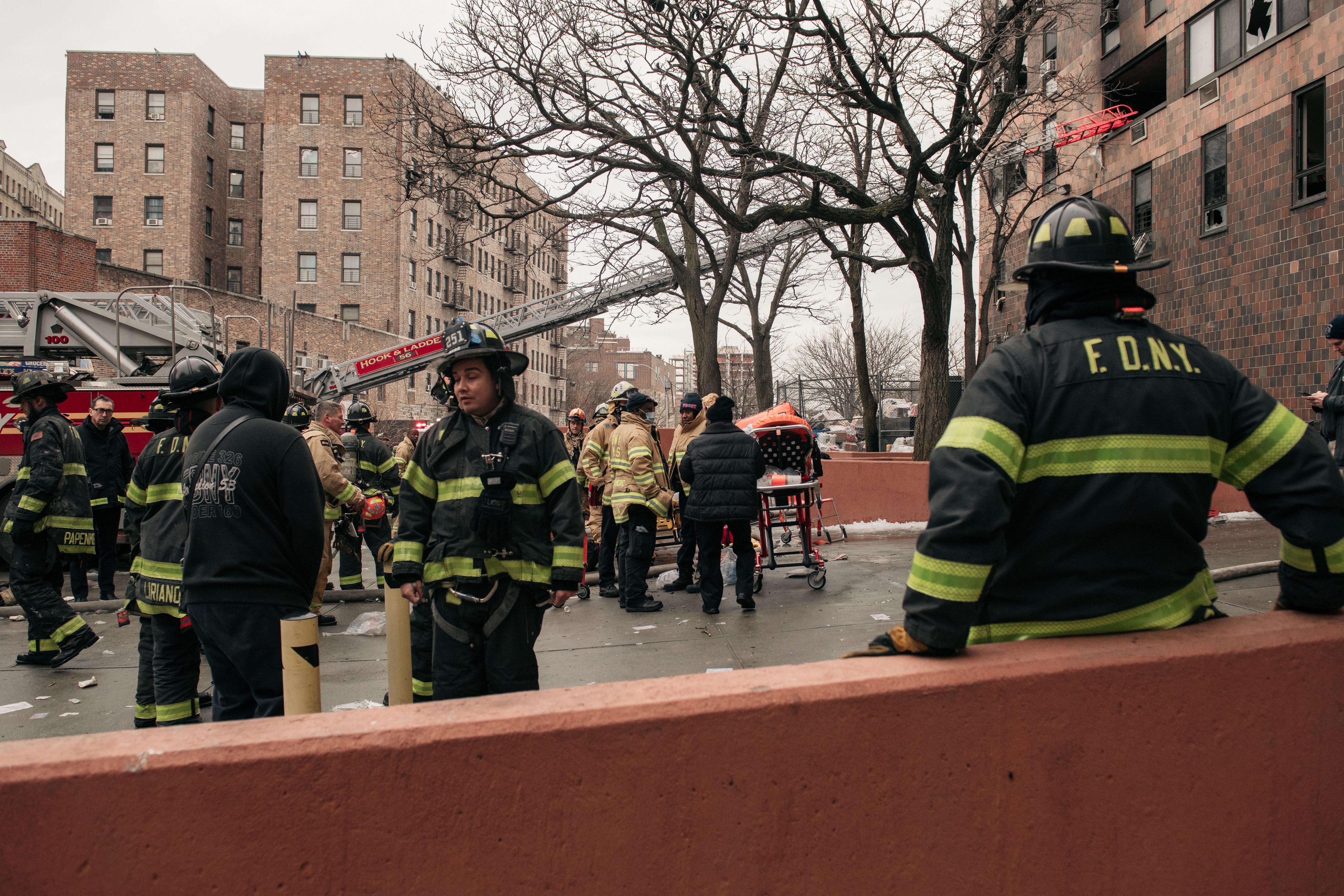 Emergency first responders remain at the scene after an intense fire at a 19-story residential building that erupted in the morning on January 9, 2022 in the Bronx (AFP) Emergency first responders remain at the scene after an intense fire at a 19-story residential building that erupted in the morning on January 9, 2022 in the Bronx (AFP)