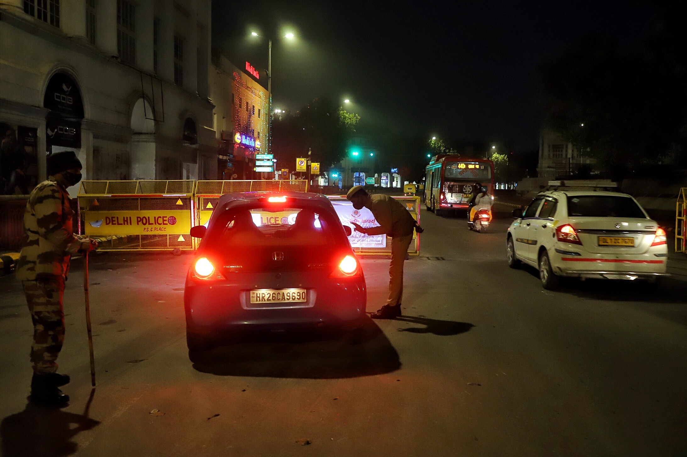 Delhi Police personnel stop a vehicle during a weekend curfew imposed by the amid rising Covid-19 cases, at Connaught place.&nbsp; (ANI Photo)