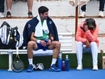 Serbian tennis player Novak Djokovic talks to his assistant Pepe Imaz