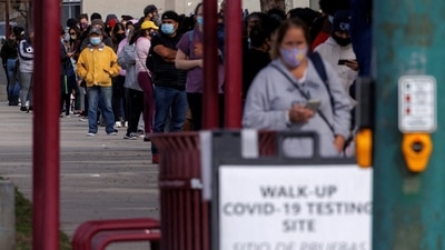 People wait outside a community center as long lines continue for individuals trying to be tested for Covid-19 in San Diego, California. (Reuters)