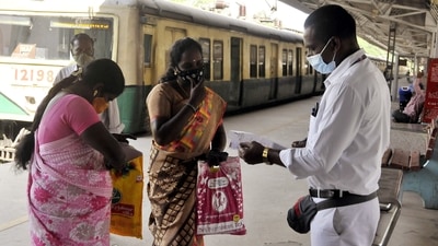 A railway staff checks the Covid-19 vaccination certificates of a passenger before allowing them to board the train in view of Omicron-driven Coronavirus surge, at a railway station in Chennai on Monday. (ANI Photo) A railway staff checks the Covid-19 vaccination certificates of a passenger before allowing them to board the train in view of Omicron-driven Coronavirus surge, at a railway station in Chennai on Monday. (ANI Photo)