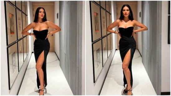 Esha Gupta can pull off any outfit with ease. In this photo uploaded on her Instagram handle, the actor redefined elegance in a strapless black corset bustier top and a thigh-high slit drawstring high-rise skirt.(Instagram/@egupta)