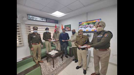 The three Home Guard volunteers who helped a rape victim being honoured by senior Chandigarh Police officials on Tuesday. (HT Photo)