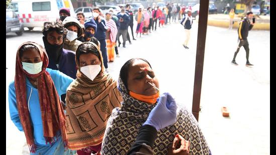 A health worker takes a swab sample for Covid-19 test at a health centre in Wazirabad, Gurugram, on Tuesday. (Vipin Kumar /HT PHOTO)