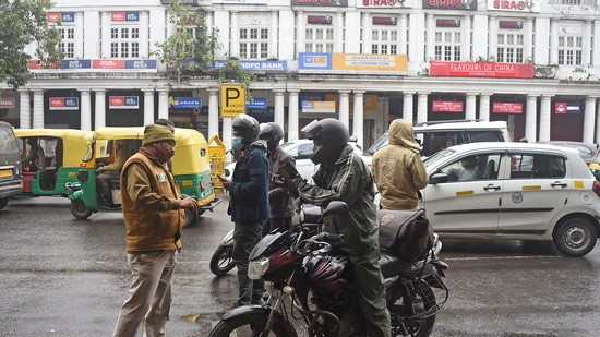 New Delhi, Jan 08 (ANI): Delhi Police personnel checking vehicles during the weekend curfew to curb the spread of COVID-19 cases, at Connaught Place, in New Delhi on Saturday. (ANI Photo)(Shrikant Singh) New Delhi, Jan 08 (ANI): Delhi Police personnel checking vehicles during the weekend curfew to curb the spread of COVID-19 cases, at Connaught Place, in New Delhi on Saturday. (ANI Photo)(Shrikant Singh)