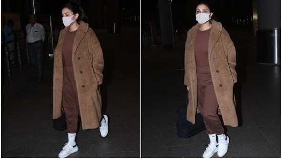 Parineeti layered up the athleisure fit with a faux fur longline brown coat featuring notch lapel collars, black buttons on the front and an oversized fit. If you wish to amp up your airport looks this winter, take cues from the actor.(HT Photo/Varinder Chawla)