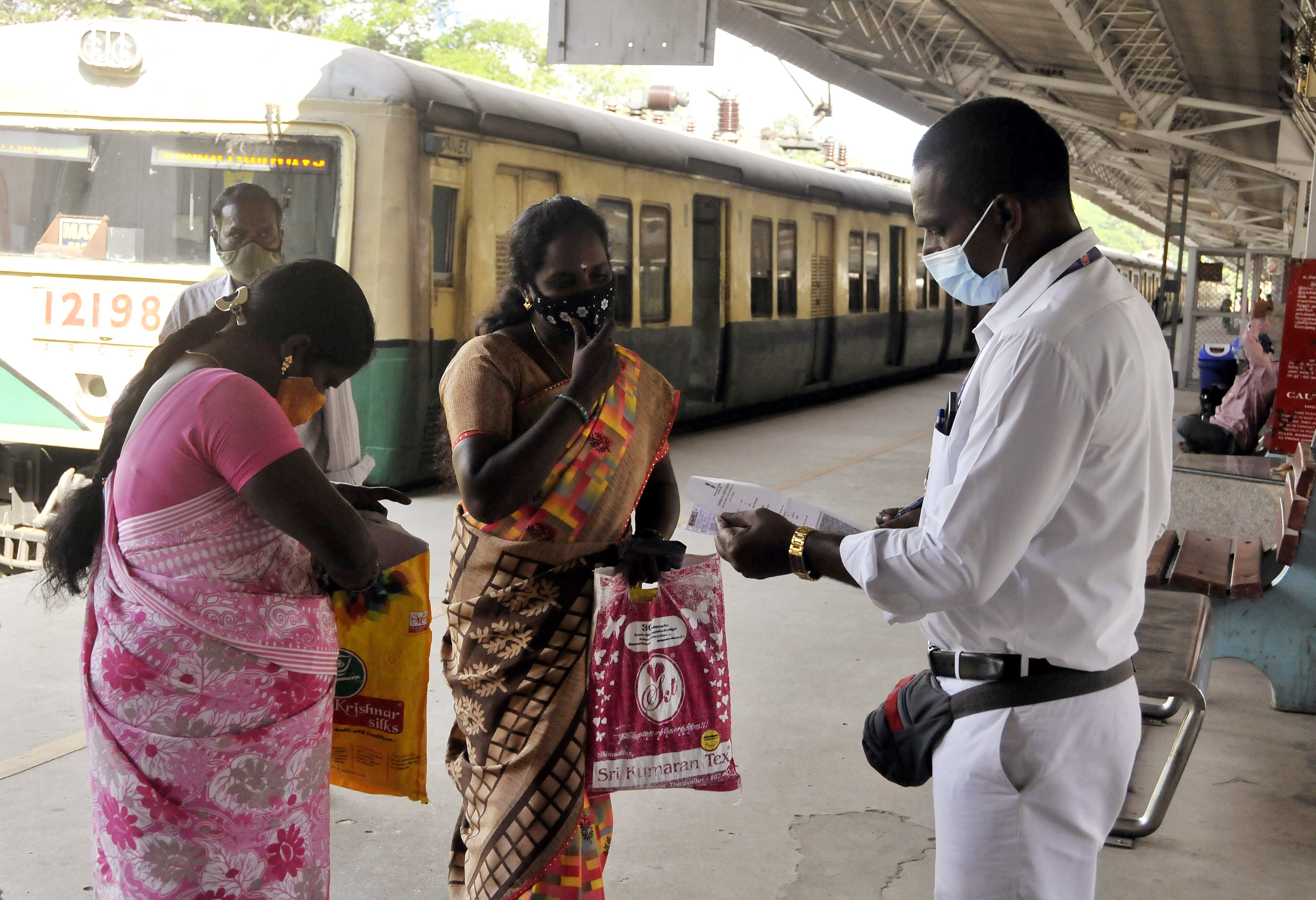 A railway staff checks the Covid-19 vaccination certificates of a passenger before allowing them to board the train, at a railway station in Chennai. (ANI file photo) A railway staff checks the Covid-19 vaccination certificates of a passenger before allowing them to board the train, at a railway station in Chennai. (ANI file photo)