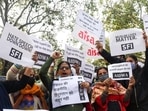 AISA and other organisations’ supporters hold placards as they stage a protest against the hate speech in Haridwar outside Uttrakhand Bhawan, in New Delhi